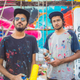 The street artists Do and Khatra in front of their mural at the Sassoon Docks.